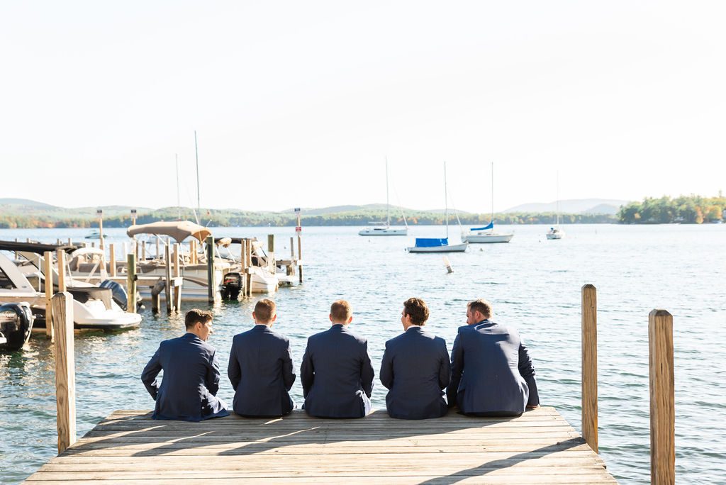 groomsmen sitting on dock