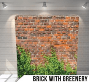 brick with greenery photo booth backdrop