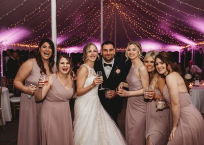 Wedding bistro lights in tent with pink uplighting